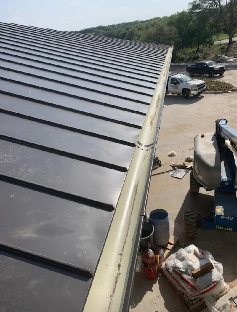Standing seam panel and gutter detail on a metal roofing jobsite in German Flatts